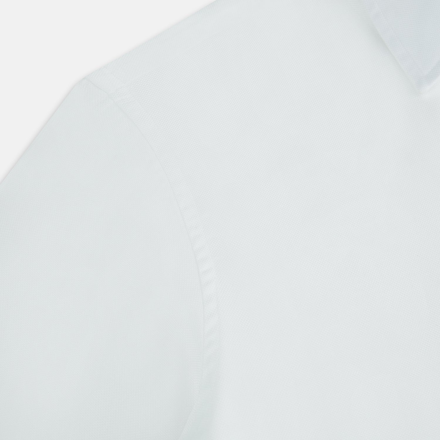 View 6 of product The Turnbull & Asser White Royal Oxford Cotton Windsor Shirt features a Turnbull open collar, long sleeves, 3-button cuffs, and a straight hem, shown against a plain white background.