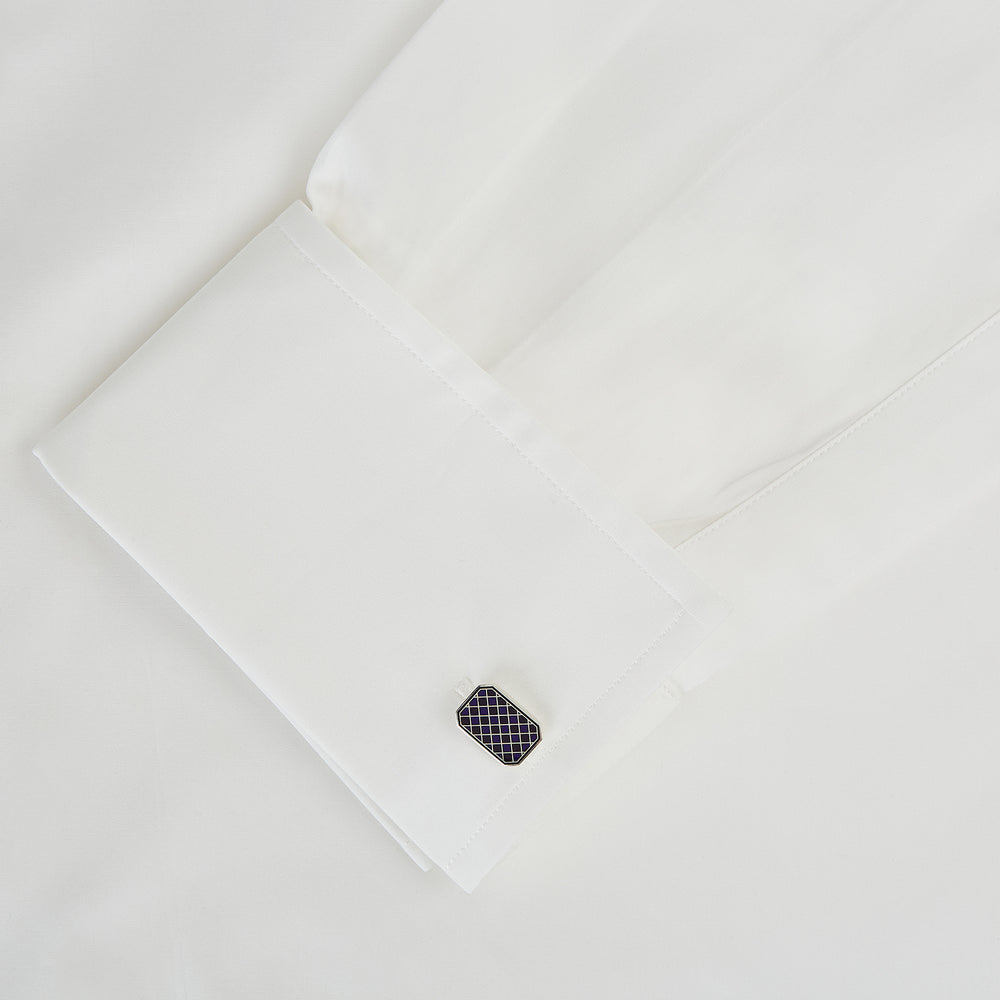 The Turnbull & Asser Navy Checkered Rectangular Enamel Cufflinks feature dark blue enamel faces with a gold grid pattern, blending masculine elegance with timeless style.