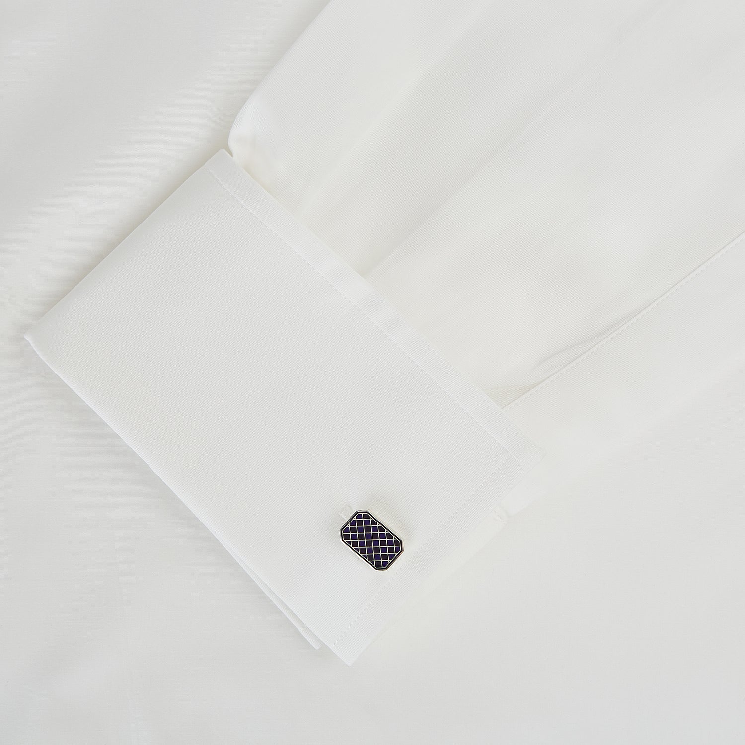 View 3 of product The Turnbull & Asser Navy Checkered Rectangular Enamel Cufflinks feature dark blue enamel faces with a gold grid pattern, blending masculine elegance with timeless style.