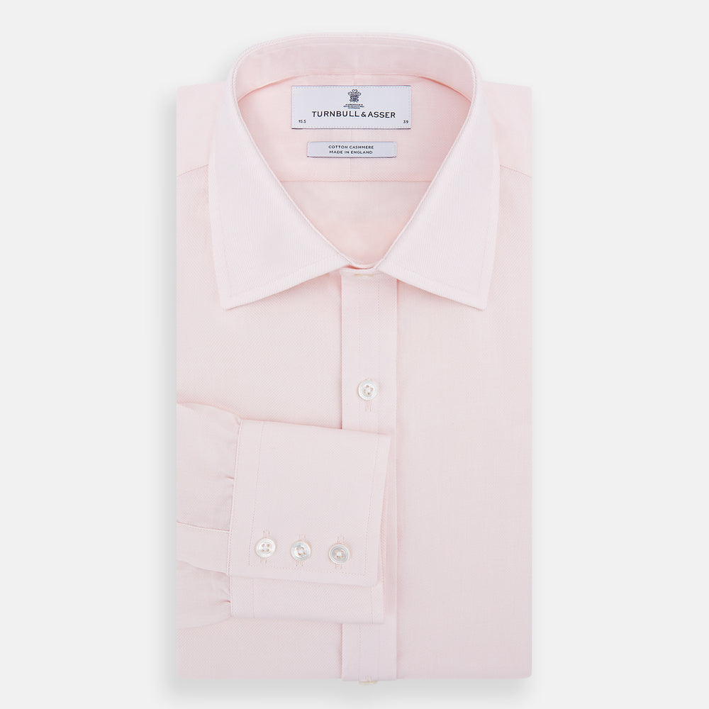 The Pale Pink Cotton Cashmere Mayfair Shirt by Turnbull & Asser features a classic collar, button-down front, and buttoned cuffs, crafted from a luxurious cotton-cashmere blend and displayed flat on a white background.