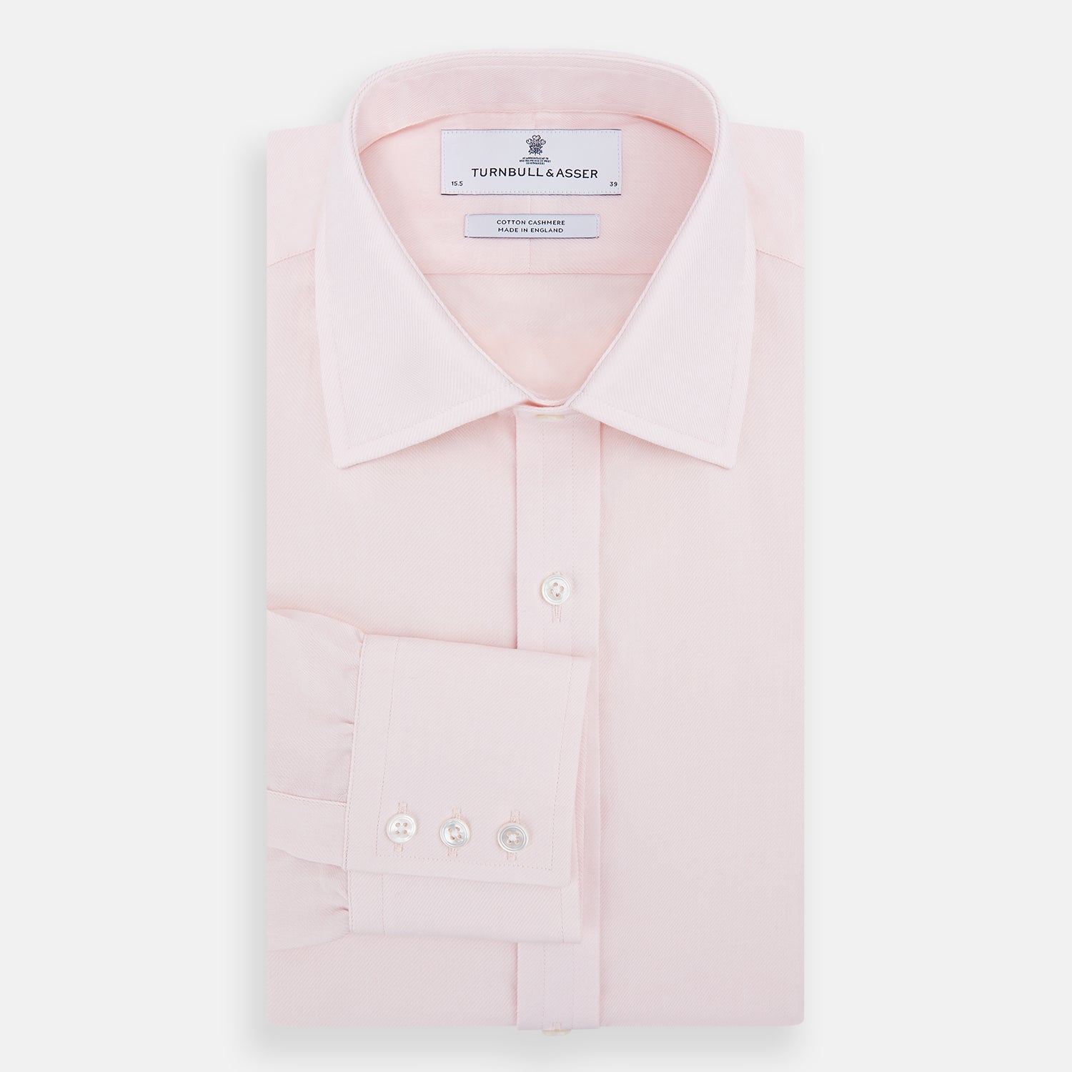 View 5 of product The Pale Pink Cotton Cashmere Mayfair Shirt by Turnbull & Asser features a classic collar, button-down front, and buttoned cuffs, crafted from a luxurious cotton-cashmere blend and displayed flat on a white background.