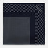 View 3 of product The Turnbull & Asser Navy and White Dot Silk Pocket Square features evenly spaced white polka dots on navy, a solid navy border, and one folded corner to reveal the reverse side, highlighting its fine handmade craftsmanship.