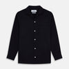 View 1 of product A Navy Cotton Holiday Fit Winnington Shirt by Turnbull & Asser, featuring long sleeves, a chest pocket, white buttons, and a revere collar, is laid flat on a white background.