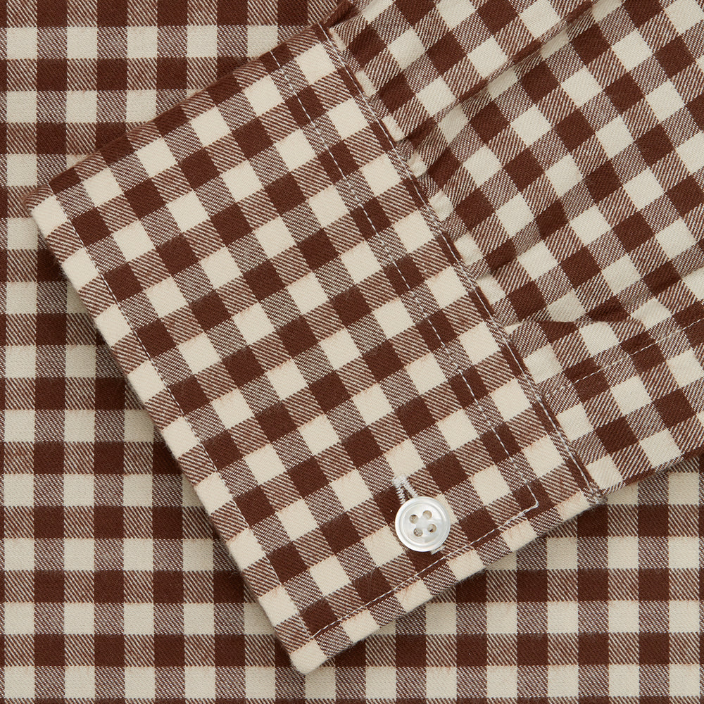 The Turnbull & Asser Brown Check Weekend Fit Shirt features a Derby collar, 1-button cuffs, and a brown check pattern—ideal for winter layering. Shown against a plain white background.