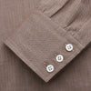 View 2 of product The Turnbull & Asser Camel Cotton Melange Regular Fit Mayfair Shirt features long sleeves, a classic T&A collar, white buttons, and buttoned cuffs in light brown cotton melange, displayed flat on a white background.
