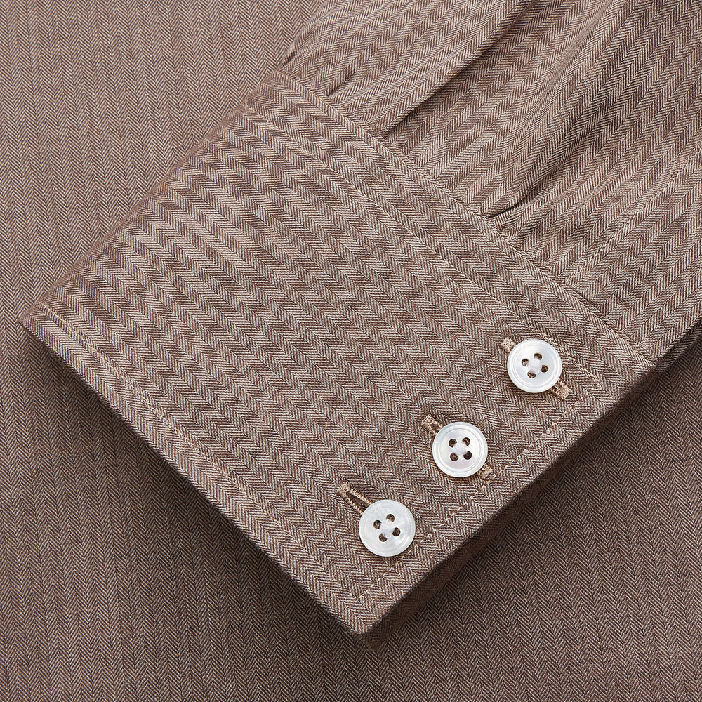The Turnbull & Asser Camel Cotton Melange Regular Fit Mayfair Shirt features long sleeves, a classic T&A collar, white buttons, and buttoned cuffs in light brown cotton melange, displayed flat on a white background.