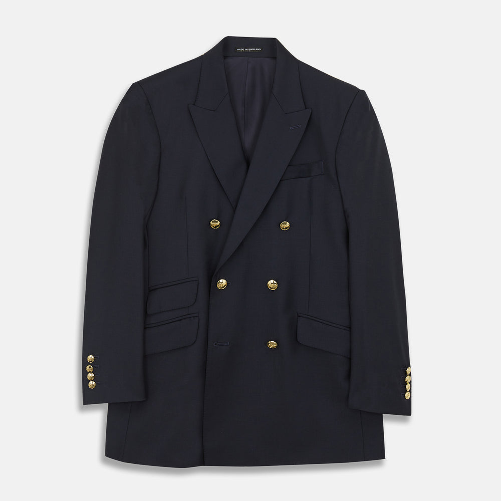 The Classic Navy Wool Blazer by Turnbull & Asser features a double-breasted design, gold buttons, notched lapels, and multiple front pockets, shown on a white background. This piece offers timeless, sophisticated nautical style.