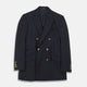 The Classic Navy Wool Blazer by Turnbull & Asser features a double-breasted design, gold buttons, notched lapels, and multiple front pockets, shown on a white background. This piece offers timeless, sophisticated nautical style.