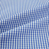 View 6 of product The Turnbull & Asser Blue Grid Check Belgravia Shirt, made from pure cotton with long sleeves, a spread collar, buttoned cuffs, and a blue-and-white check pattern, is laid flat on a white background.