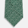 View 3 of product The Forest Green Flower Patterned Silk Tie by Turnbull & Asser features a white floral motif on silk, shown neatly rolled against a plain white background.
