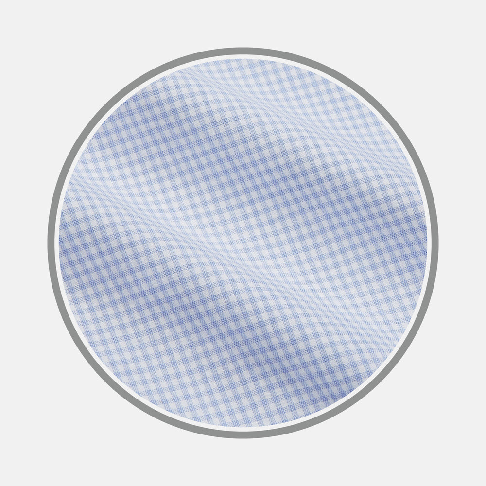 A close-up of Turnbull & Asser’s Pale Blue Multi Check Cashmerello Fabric, featuring a small light blue and white check pattern, shown within a circular frame against a plain white background.