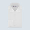 View 1 of product The Sea Island Cotton Classic Fit White Shirt by Turnbull & Asser features a classic collar and front buttons, neatly folded with its label visible, displayed on a light blue background.