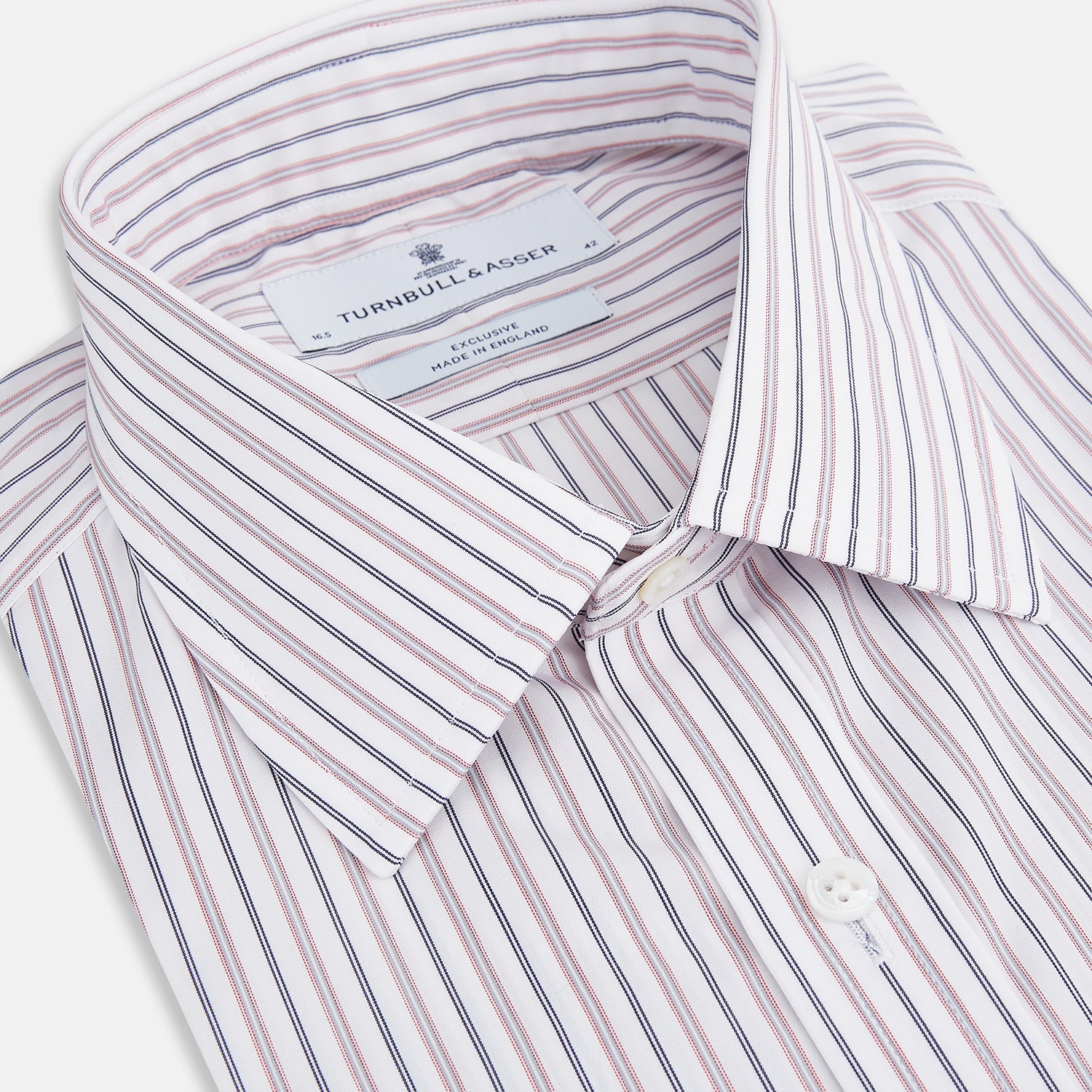 View 2 of product The Turnbull & Asser Red Multi Stripe Mayfair Shirt is a long-sleeve, button-up classic with a sharp collar and vibrant red multi stripes—an essential men's piece shown against a white background.