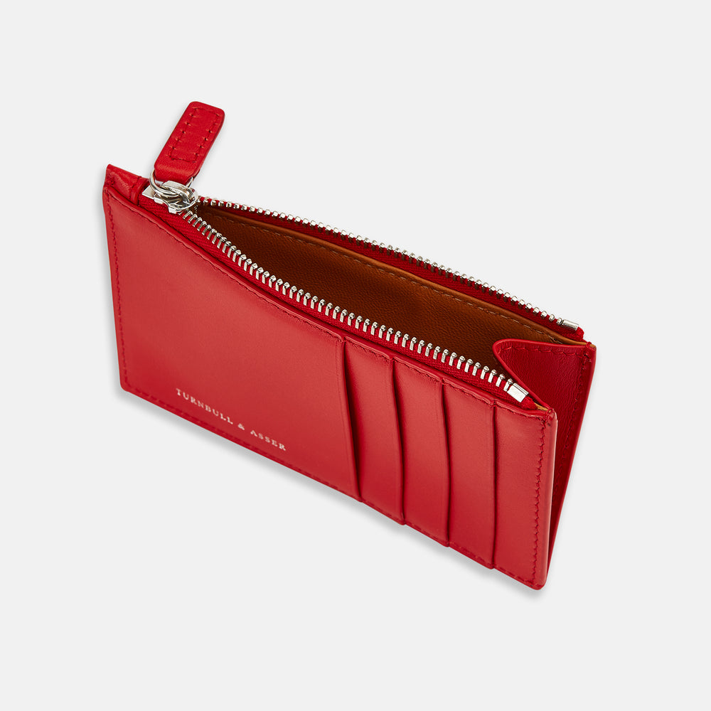 The Red Leather Zip Coin and Card Holder by Turnbull & Asser features four card slots, a slim pocket, a zip compartment, and white embossed branding on the front.