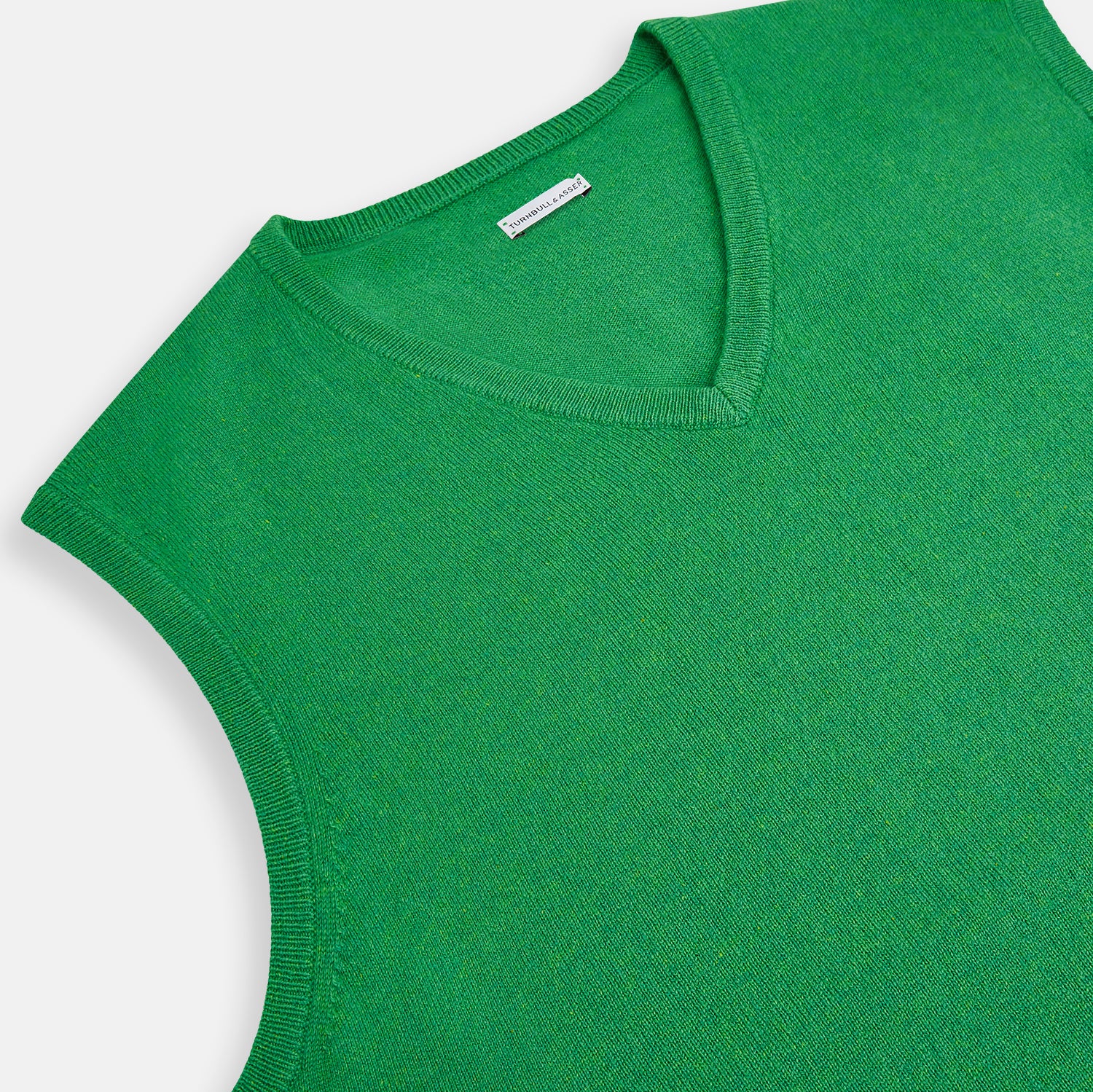 View 2 of product The Fern Green Cashmere V-Neck Vest by Turnbull & Asser is a men's sleeveless jumper, ideal for layering, shown against a plain white background.