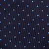 View 3 of product The LACE ON TONE SPOT NAVY FORD TIE by Turnbull & Asser is a rolled-up navy tie with textured fabric and an evenly spaced pattern of small light blue polka dots.