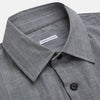 View 2 of product The Turnbull & Asser Grey Check Hampstead Overshirt features a light gray check pattern, pointed collar, chest pocket, and two zippered side pockets, displayed flat against a white background.