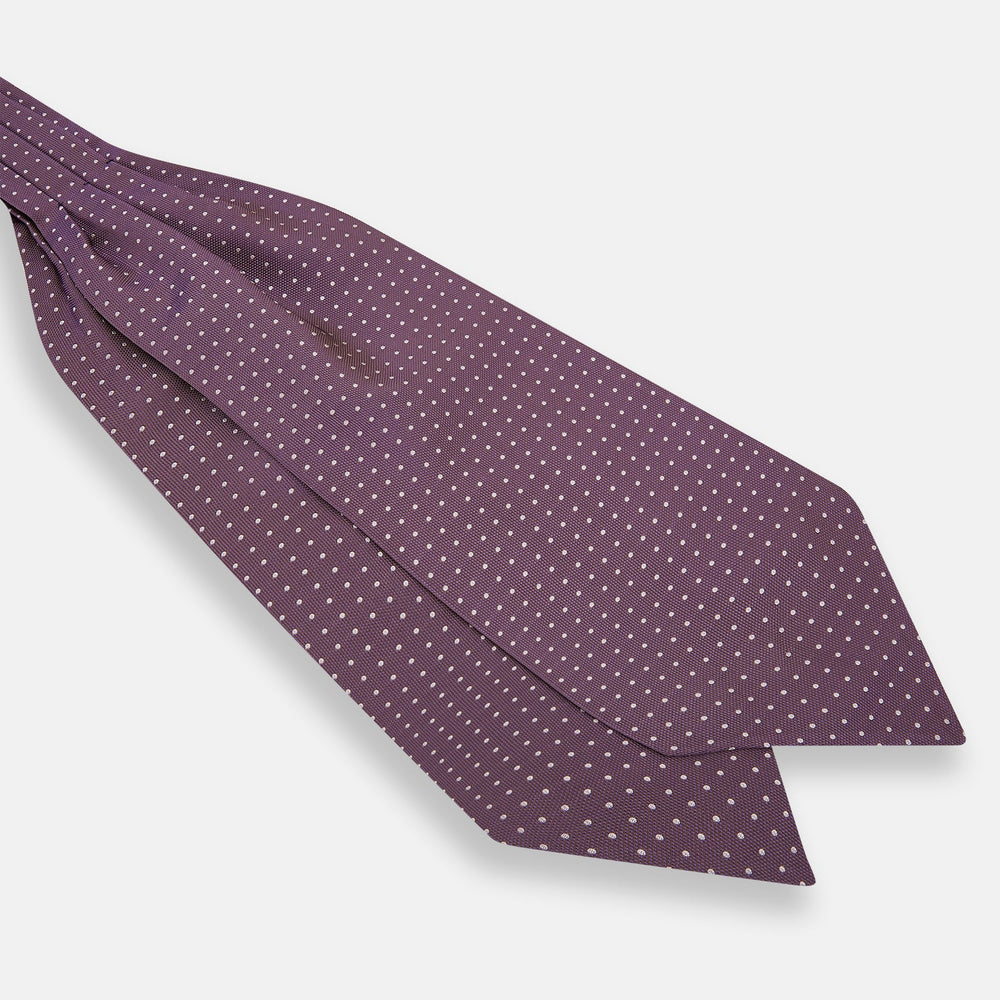 The Lilac and Violet Micro Dot Silk Cravat by Turnbull & Asser features small white polka dots on elegant silk, expertly crafted for a refined look, and is shown against a white background.