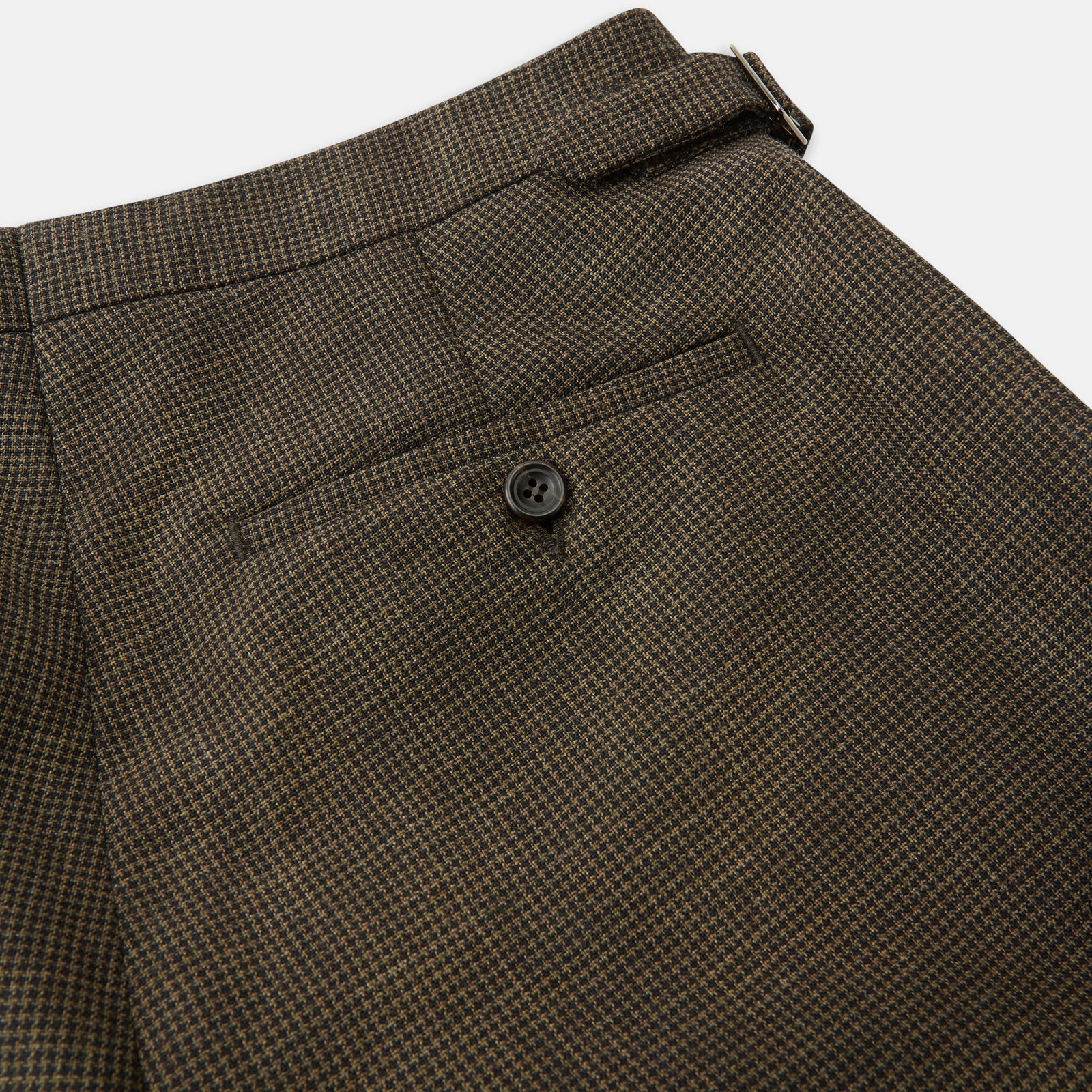View 2 of product The Brown Puppytooth Wool Jonathan Trousers by Turnbull & Asser are straight-leg tailored trousers with belt loops, side pockets, and a front crease, shown on a white background.