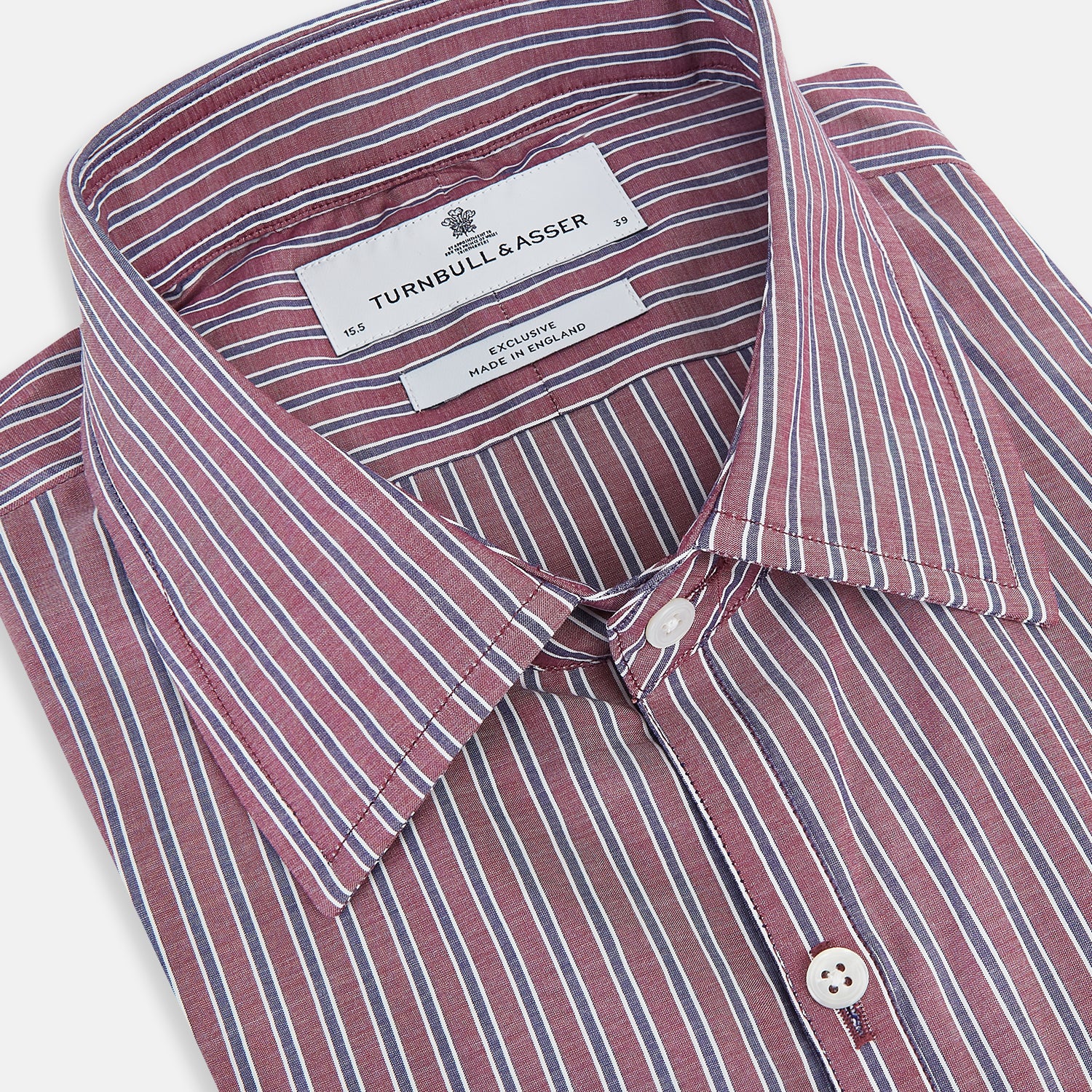 View 2 of product The Turnbull & Asser Wine Ticking Stripe Westminster Shirt features red, blue, and white vertical pinstripes on white and is shown laid flat on a white surface.