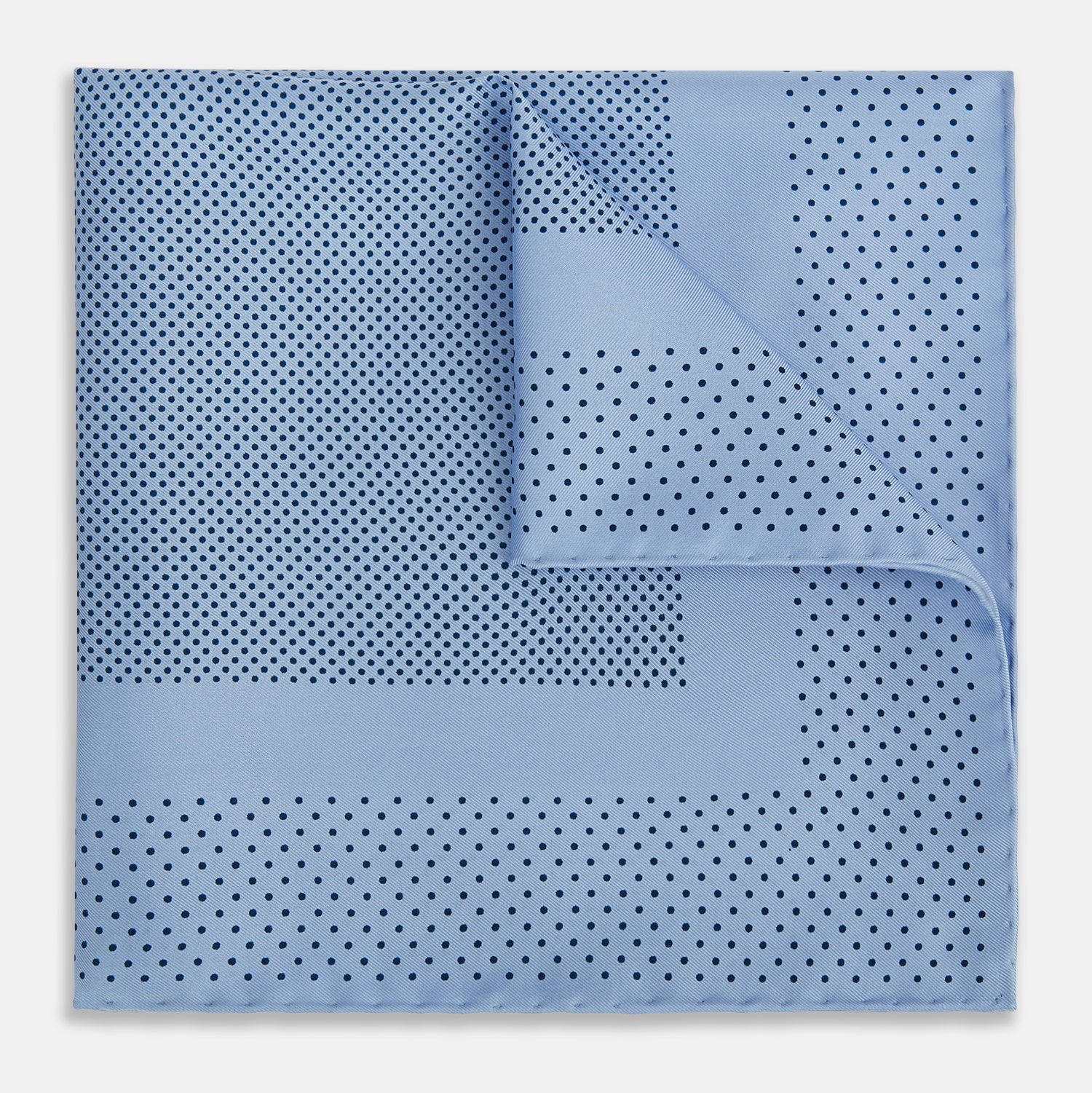 View 1 of product The Turnbull & Asser Pale Blue Dot Silk Pocket Square features pure silk in pale blue with a border and scattered small navy polka dots, neatly folded with one corner turned down.