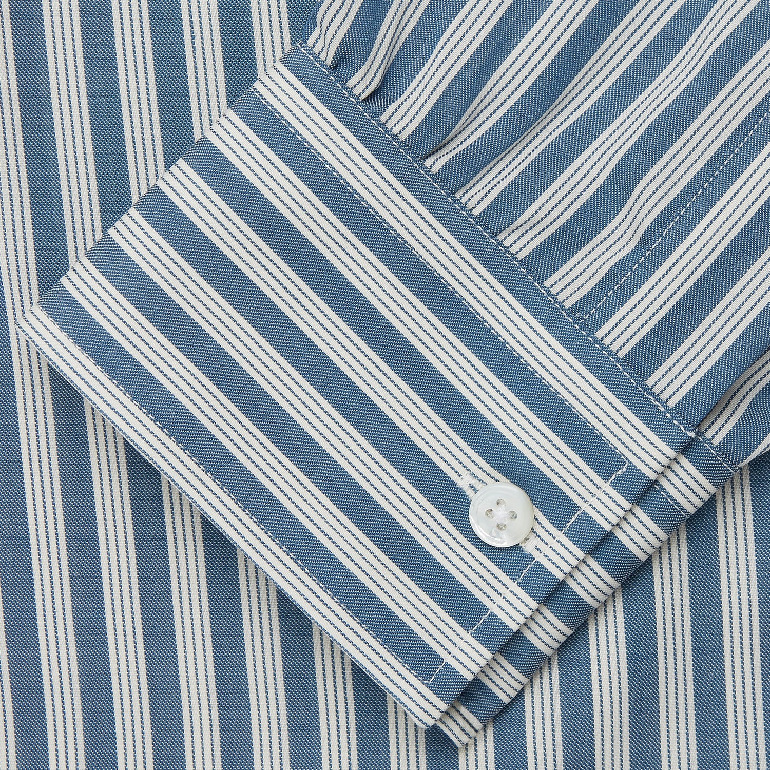 View 3 of product Turnbull & Asser’s Pale Blue Multi Stripe Weekend Fit Wool Shirt features a Derby collar, 1-button cuffs, and a chest pocket—ideal for casual layering. Shown laid flat on a white background for easy styling.