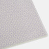 View 2 of product The Turnbull & Asser Ivory and Lilac Lozenge-Patterned Cashmere Knitted Scarf, tied loosely, reveals its refined style and geometric design against a plain white background.