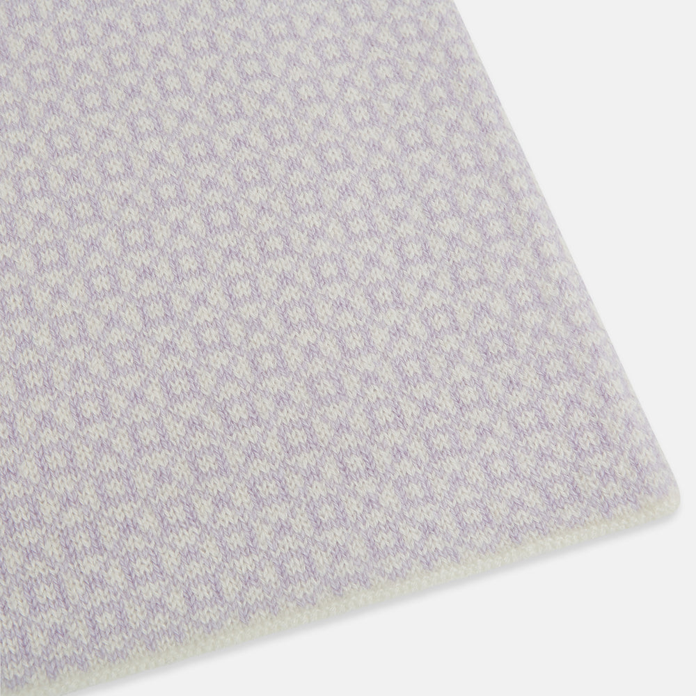 The Turnbull & Asser Ivory and Lilac Lozenge-Patterned Cashmere Knitted Scarf, tied loosely, reveals its refined style and geometric design against a plain white background.