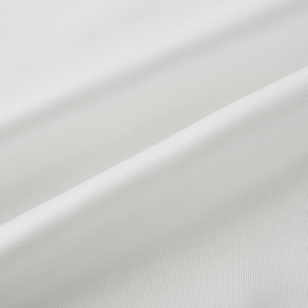The Turnbull & Asser White Silk Scarf features fringed edges and discreet black branding in the corner, making it a refined accessory for tuxedo jackets or formal wear. Presented neatly folded on a plain white background.