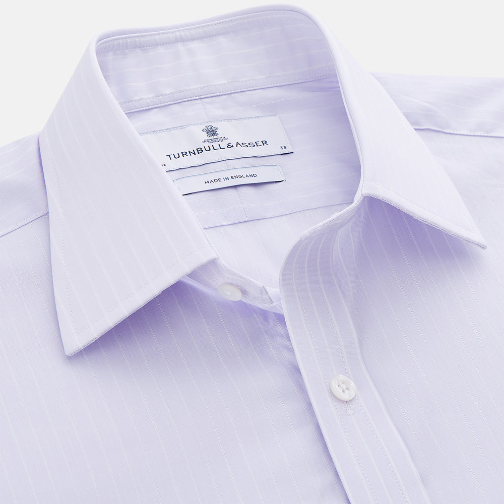 The Turnbull & Asser Soft Lilac Stripe Cotton Regular Fit Mayfair Shirt features a classic collar, cuffed long sleeves, and subtle vertical stripes, shown on a plain white background.