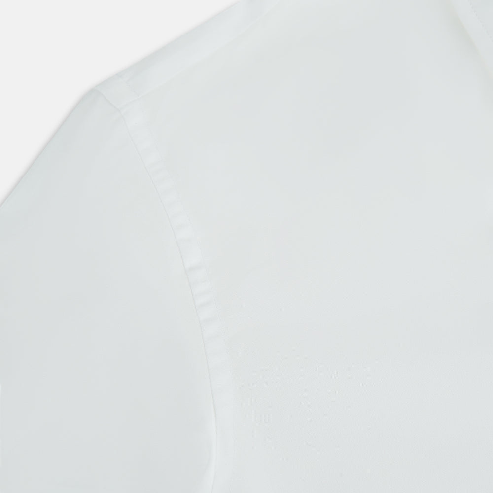 The PLAIN WHITE WESTMINSTER SHIRT WITH TURNBULL COLLAR AND 3-BUTTON CUFFS by Turnbull & Asser features refined British craftsmanship, long sleeves, a straight hem, and a crisp white design displayed on a plain background.