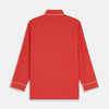 View 7 of product The Turnbull & Asser Women's Coral Pink Silk Thelma Pyjama Set features a long-sleeve button-up top with two front pockets and matching drawstring pants, shown on a white background.