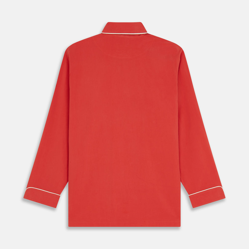The Turnbull & Asser Women's Coral Pink Silk Thelma Pyjama Set features a long-sleeve button-up top with two front pockets and matching drawstring pants, shown on a white background.