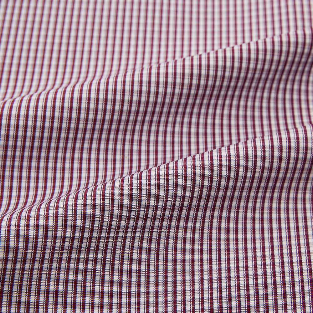 The Turnbull & Asser Burgundy Micro Check Mayfair Shirt features long sleeves, a pointed collar, and white buttons—perfect for formal wear. Shown laid flat on a white background.