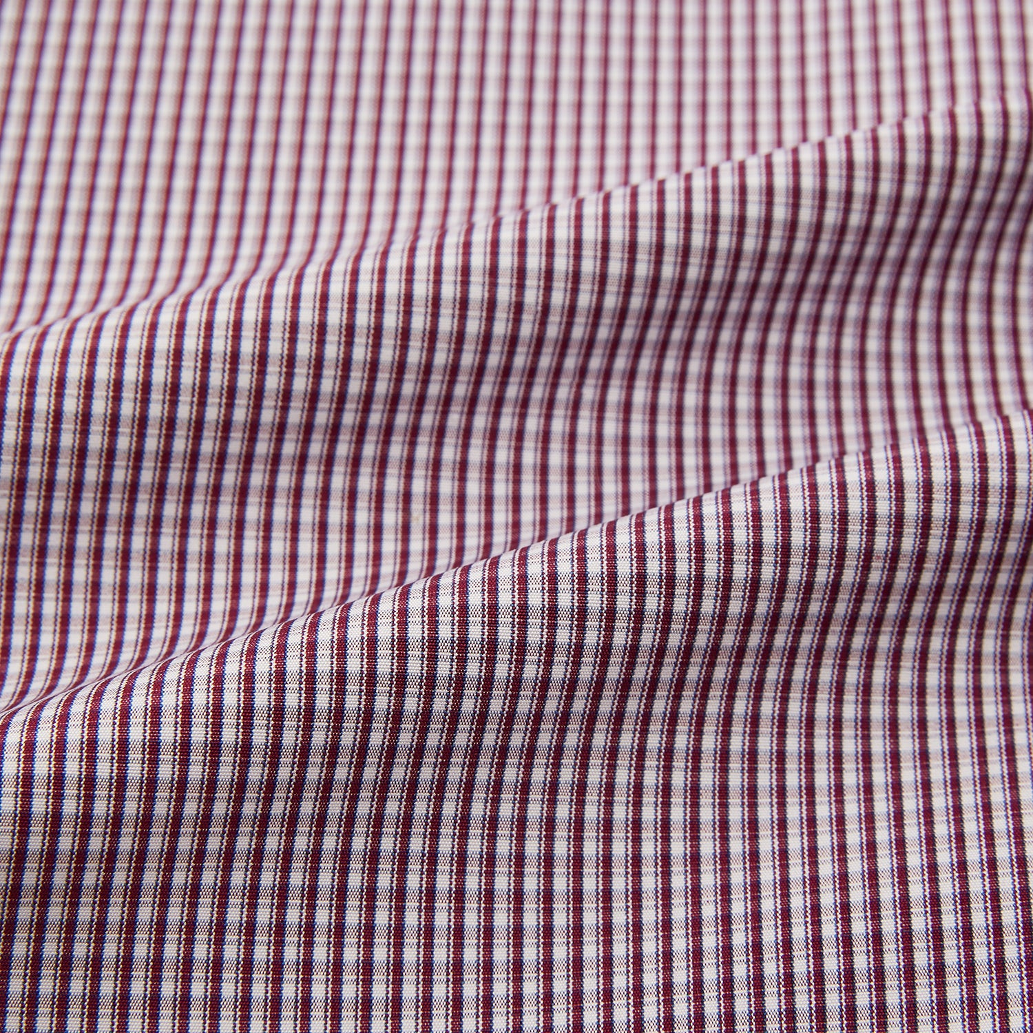 View 6 of product The Turnbull & Asser Burgundy Micro Check Mayfair Shirt features long sleeves, a pointed collar, and white buttons—perfect for formal wear. Shown laid flat on a white background.