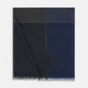 View 3 of product The Charcoal and Navy Cashmere Scarf by Turnbull & Asser features a color block design in dark hues, raw fringed edges, and a soft, smooth texture, elegantly displayed against a white background.