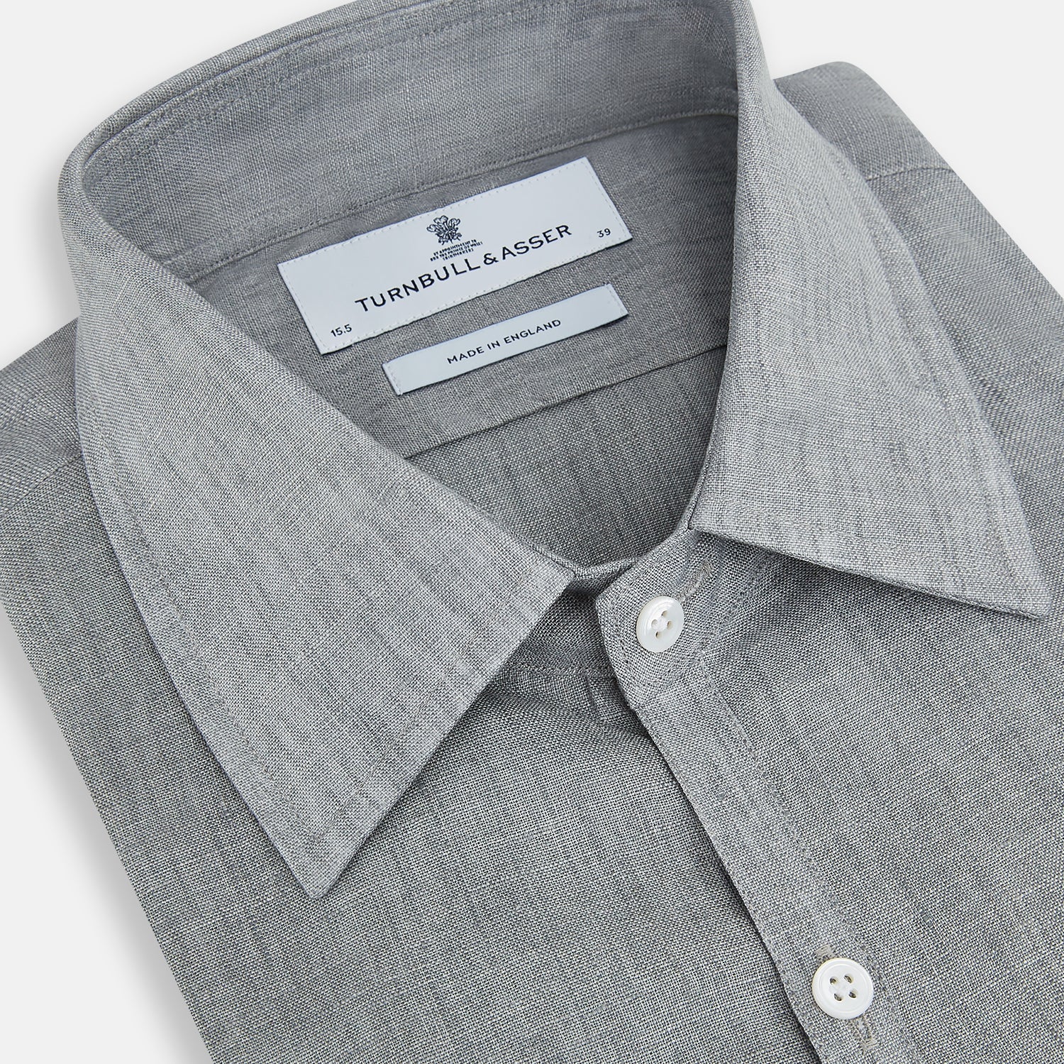 View 2 of product The Grey Linen Westminster Shirt by Turnbull & Asser is a long-sleeve, light gray button-up with a formal collar and white buttons, highlighting British craftsmanship and laid flat on a white background.