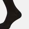 View 4 of product A single Turnbull & Asser Black Wool Mid-Length Sock is displayed on a plain white background, angled to reveal its full length from toe to cuff.