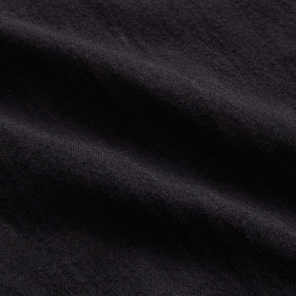 A navy button-up Primrose overshirt by Turnbull & Asser with a classic collar, two side pockets, a left chest pocket, and buttoned cuffs—an ideal blazer alternative, shown on a plain white background.