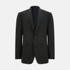 View 1 of product The Turnbull & Asser Charcoal Glen Check Sports Jacket features a dark plaid pattern, single-button closure, notched lapels, and two front flap pockets, shown against a plain white background—an essential for any men's wardrobe.