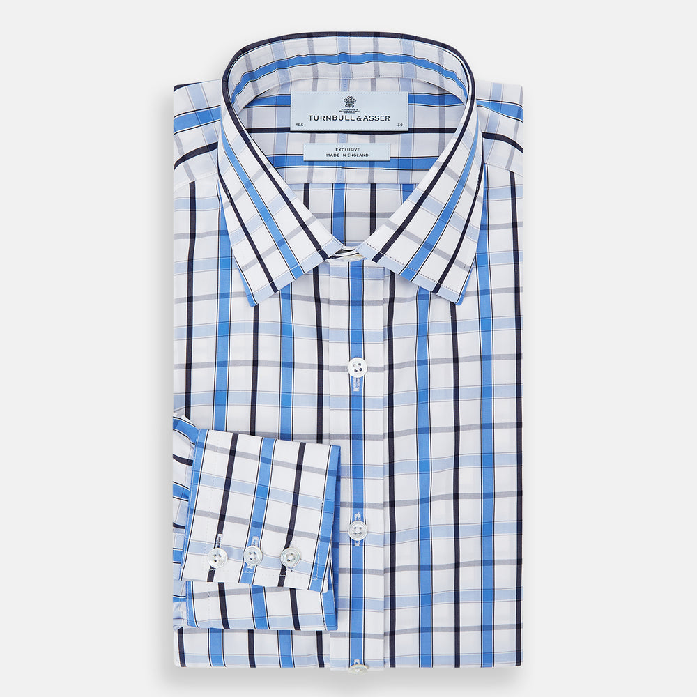 The Turnbull & Asser Blue and Navy Combination Check Mayfair Shirt features a classic button-up style with long sleeves, T&A collar, and a blue, navy, and white check pattern, shown against a plain white background.