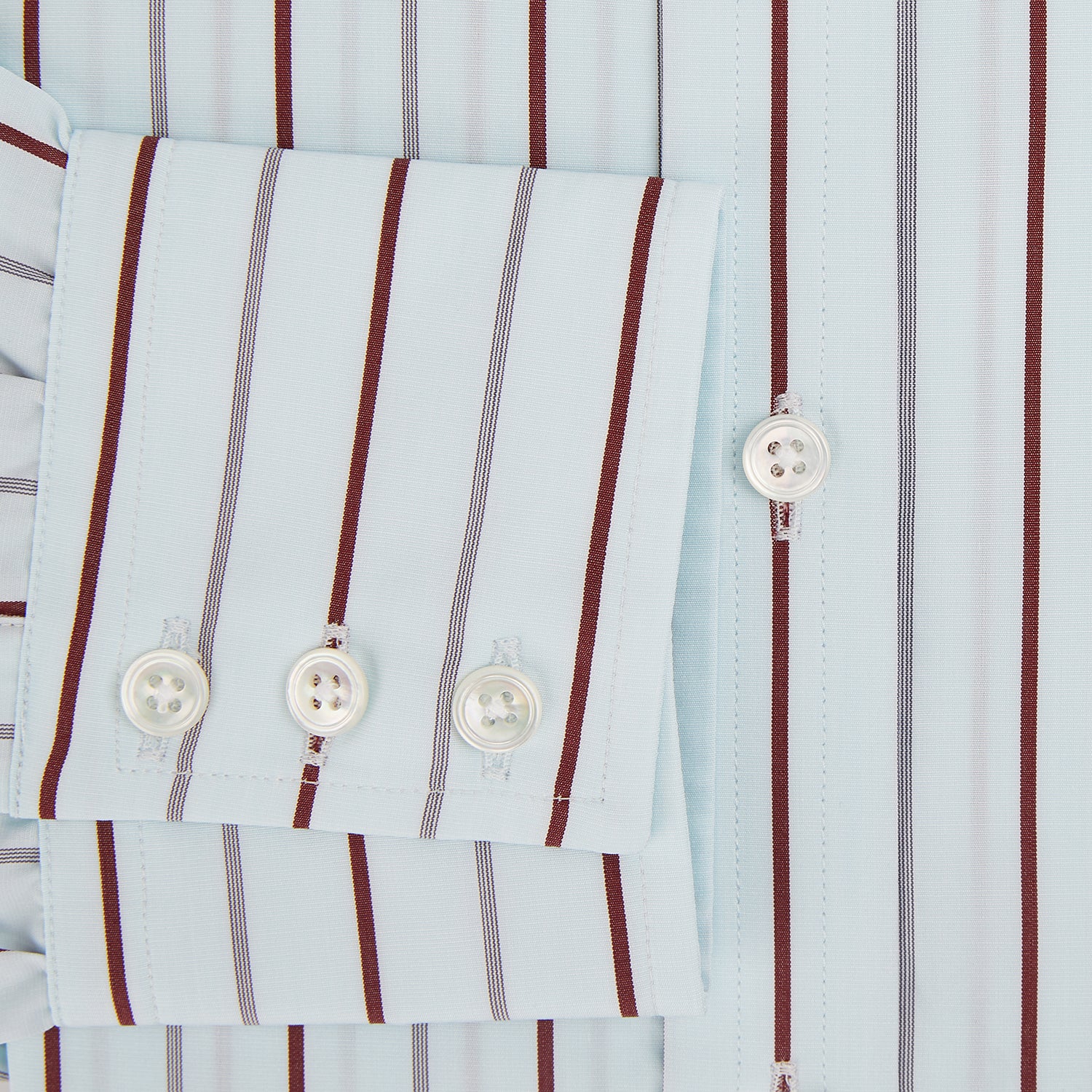 View 4 of product The Turnbull & Asser Burgundy Combination Stripe Mayfair Shirt features long sleeves, a classic T&A collar, and vertical black and burgundy stripes on white, laid flat against a plain white background.