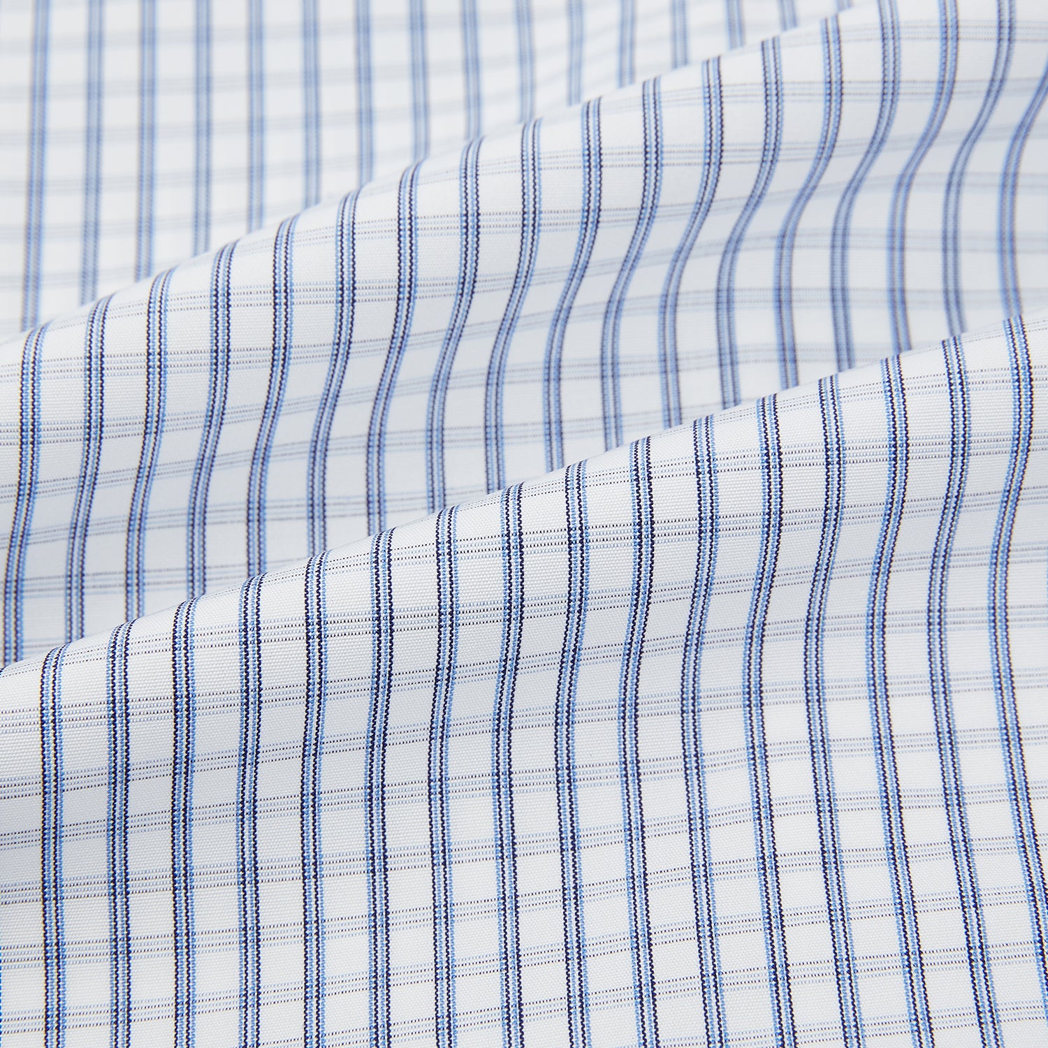 View 6 of product The Turnbull & Asser Blue Multi Tattersall Check Mayfair Shirt is a long-sleeved, button-down shirt featuring a small blue and white check pattern, pointed collar, and cuffs, shown laid flat on a white background.