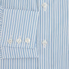 View 4 of product The Turnbull & Asser Sky Blue Double Stripe Mayfair Shirt features sky blue and white vertical stripes, a T&A collar, buttoned cuffs, and is displayed flat on a white background.