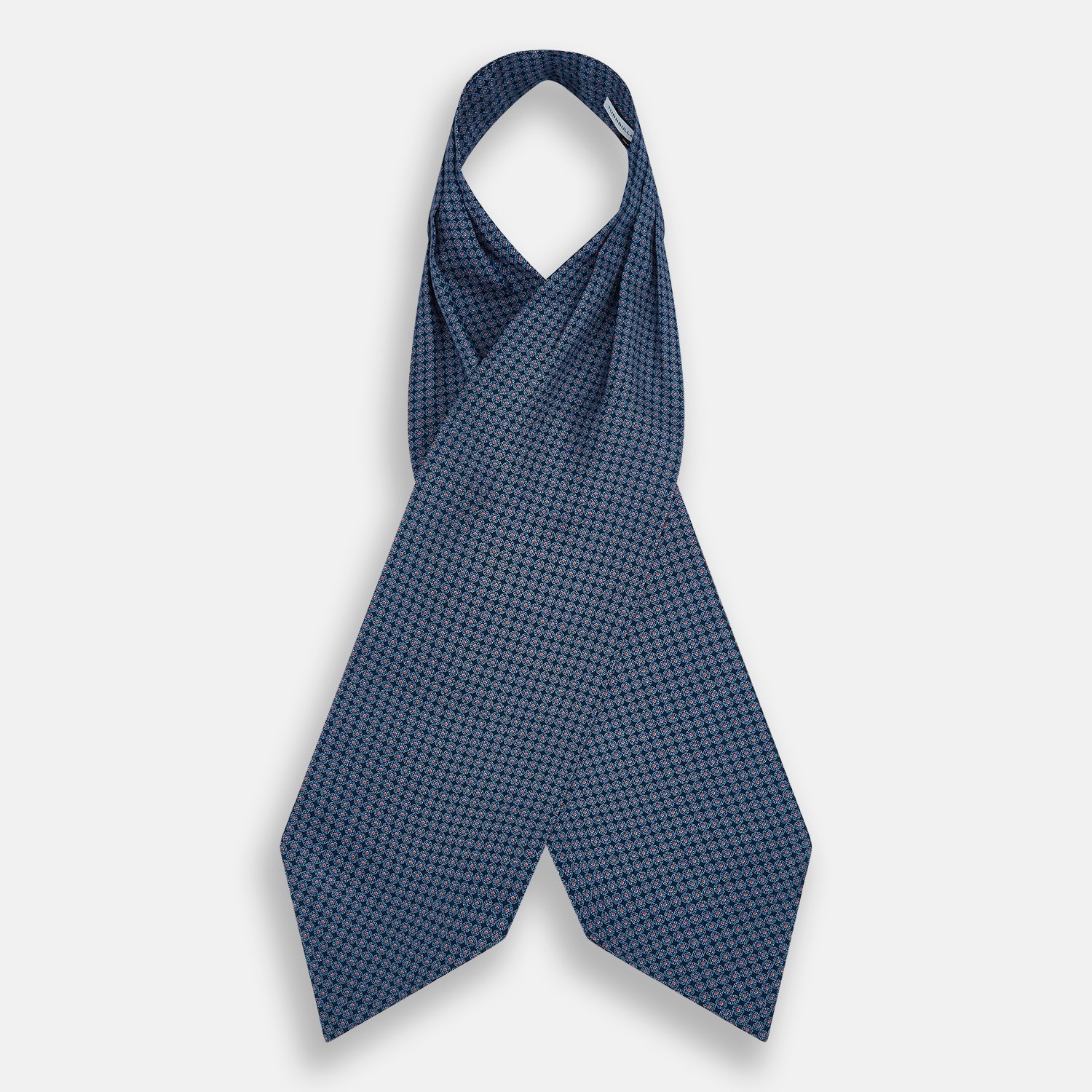 View 2 of product The Turnbull & Asser Navy and Red Rosette Cravat is adorned with a repeating geometric pattern of red, white, and light blue circles—an ideal formal accessory displayed against a white background.