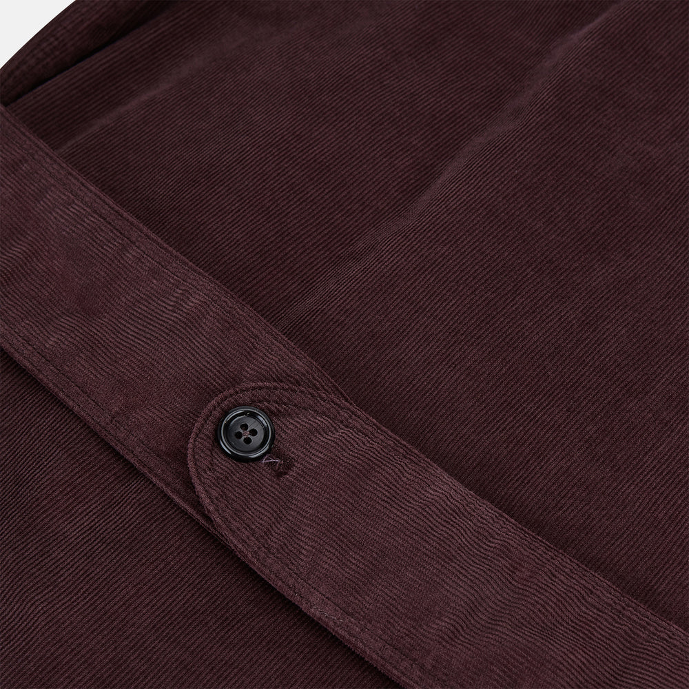 The Burgundy Kingston Corduroy Caban Jacket by Turnbull & Asser features black buttons, a notched collar, and front pockets. Crafted from premium cotton, it is shown on a plain white background.