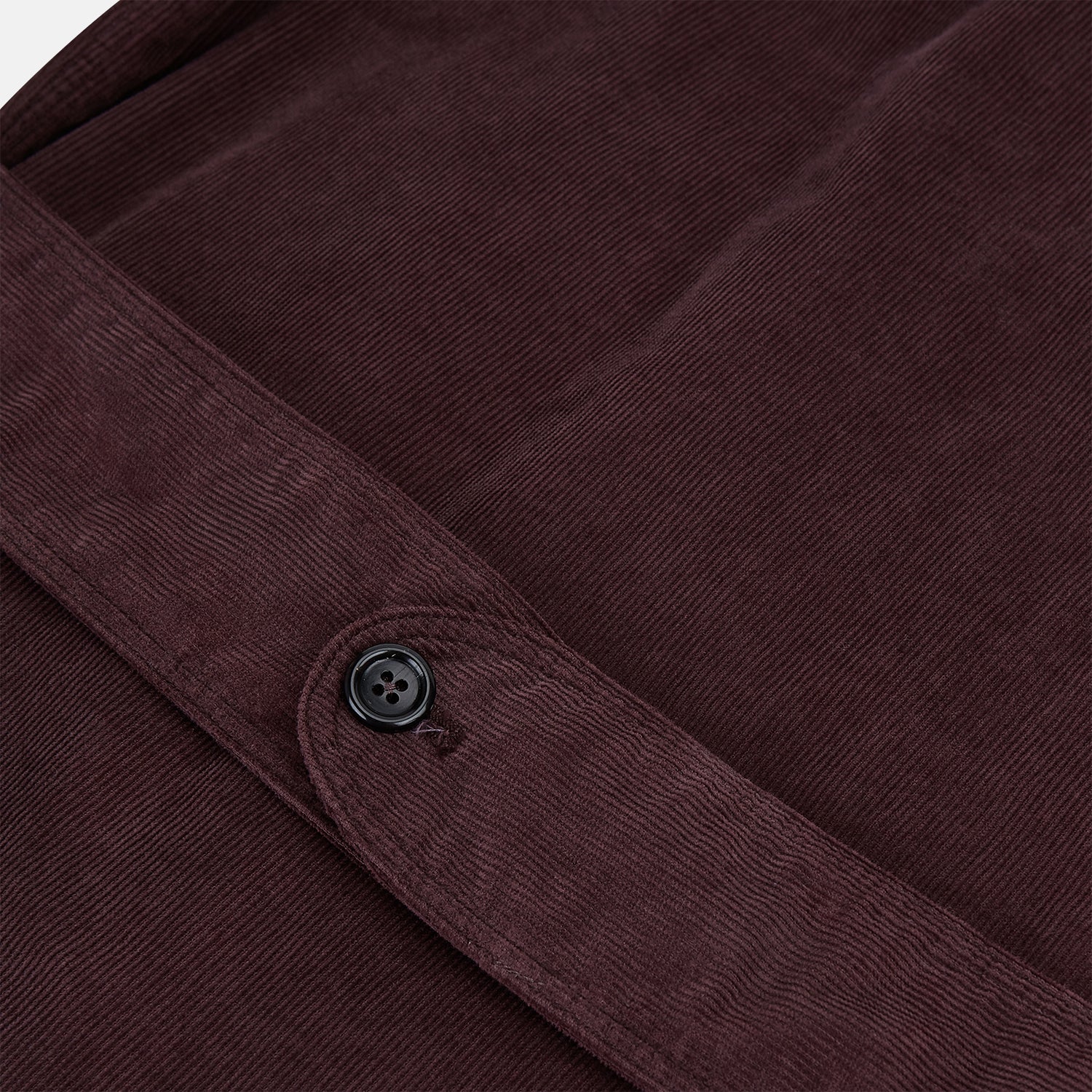 View 4 of product The Burgundy Kingston Corduroy Caban Jacket by Turnbull & Asser features black buttons, a notched collar, and front pockets. Crafted from premium cotton, it is shown on a plain white background.