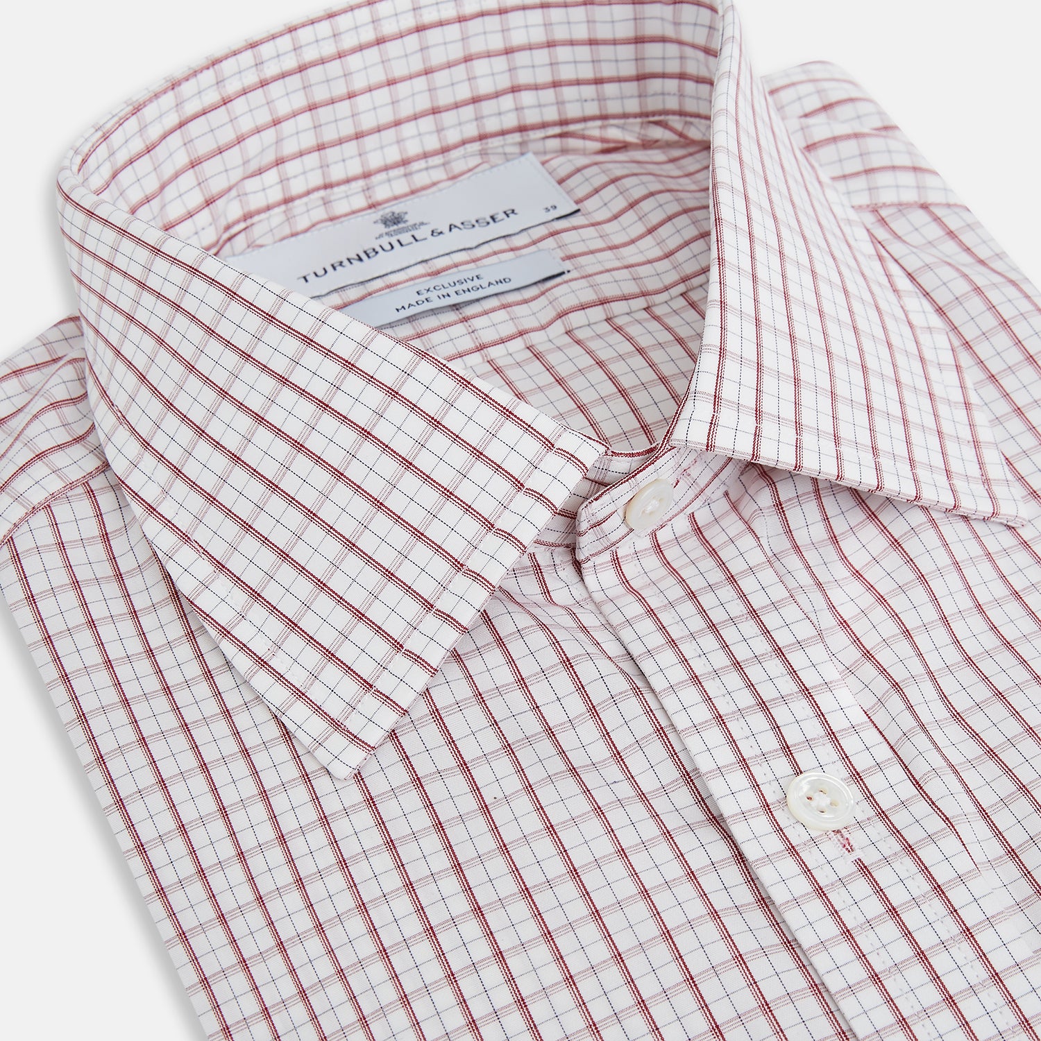 View 2 of product The Turnbull & Asser Red Tattersall Check Mayfair Shirt features long sleeves, a collar, and Italian cotton with a red tattersall check on white, shown flat against a white background.