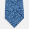 View 3 of product The Turnbull & Asser Azzurro Paisley Silk Tie showcases an intricate light blue paisley pattern on rich blue silk, presented rolled up on a white background.