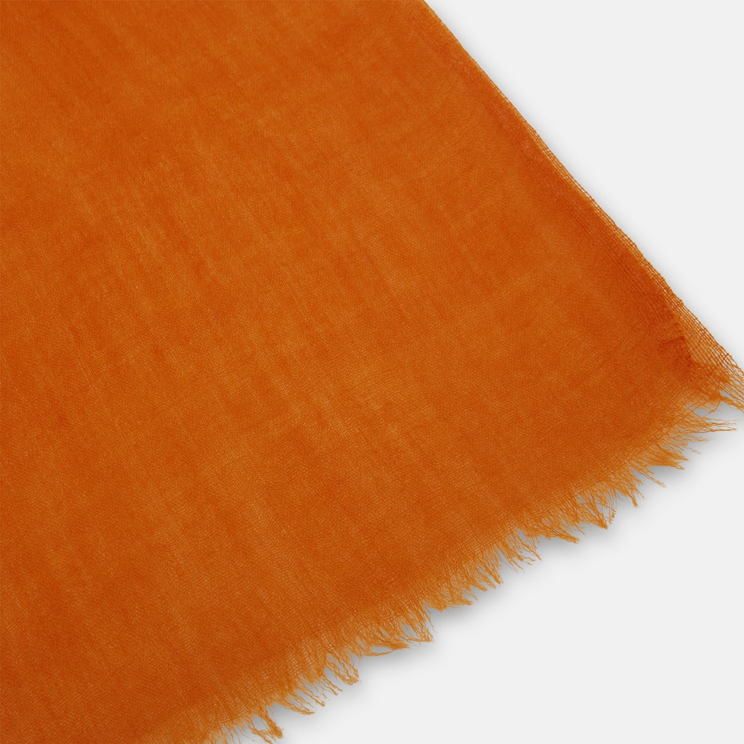View 2 of product The Orange Cashmere Scarf by Turnbull & Asser features a soft texture, fringed edges, and a rich orange hue—an elegant luxury accessory displayed on a white background.